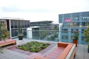 banquette avec coussins rayée orange et rouge sur la terrasse sncf